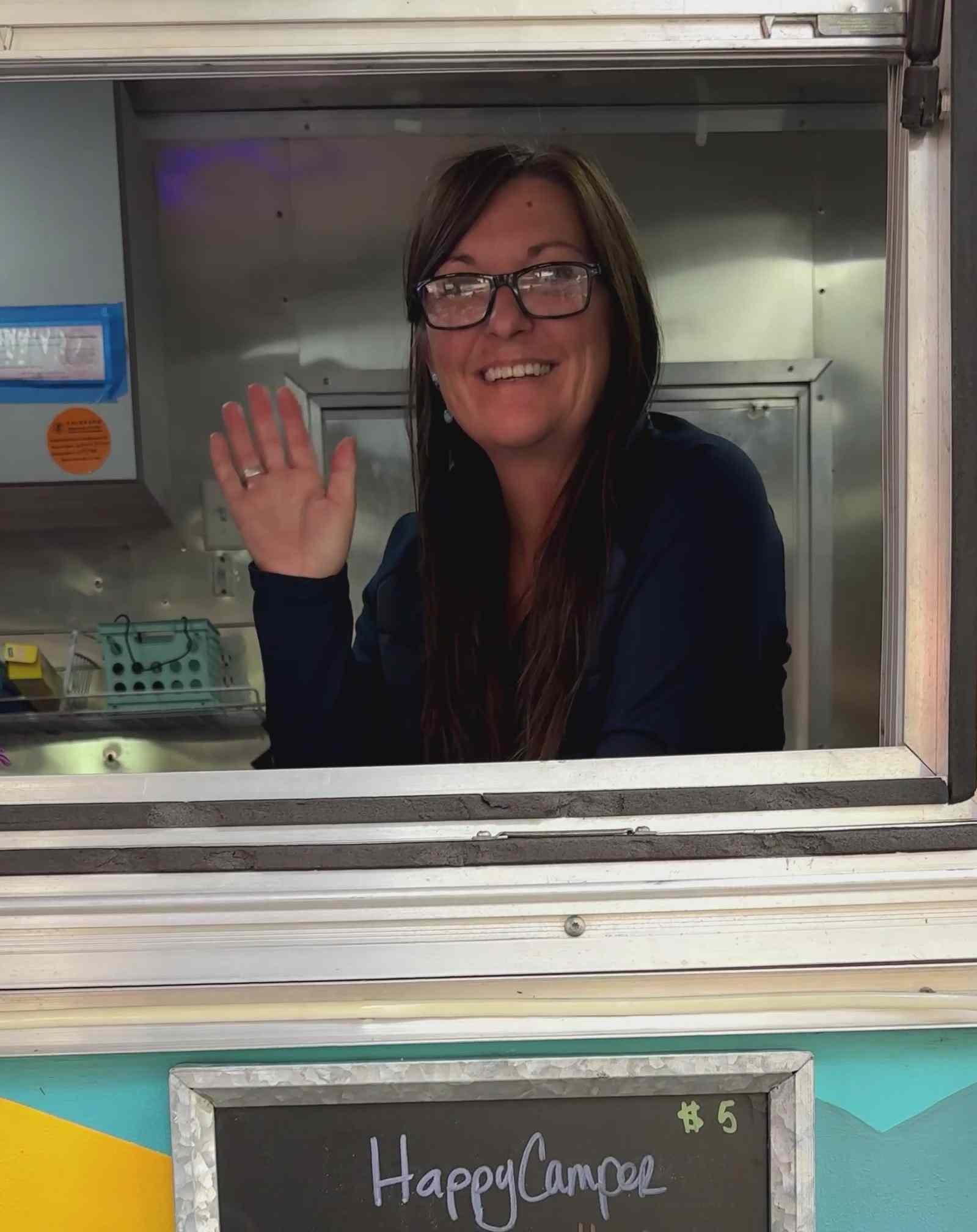 Aimee Strevay waving from the trailer's service window