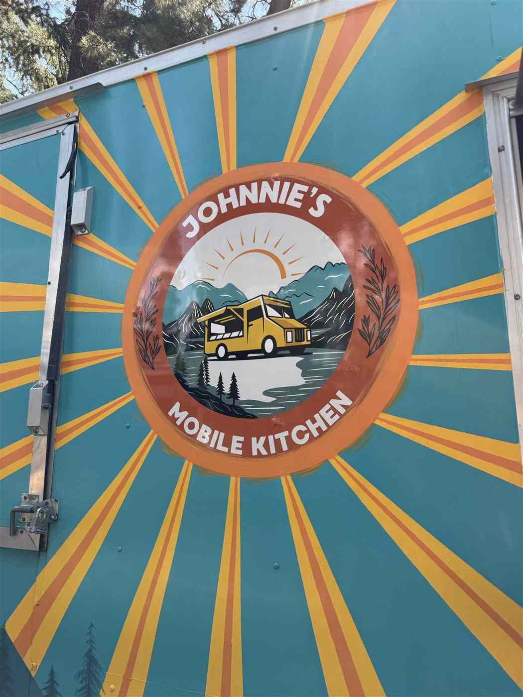 The painted sunburst logo under the trailer's awning